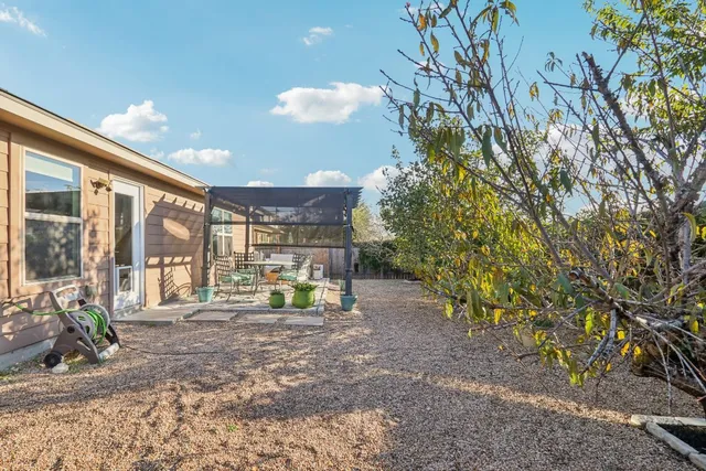 a view of a chair and tables in the patio