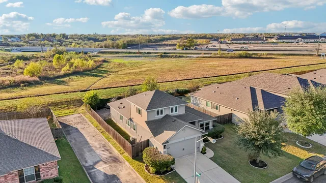 an aerial view of residential houses with outdoor space