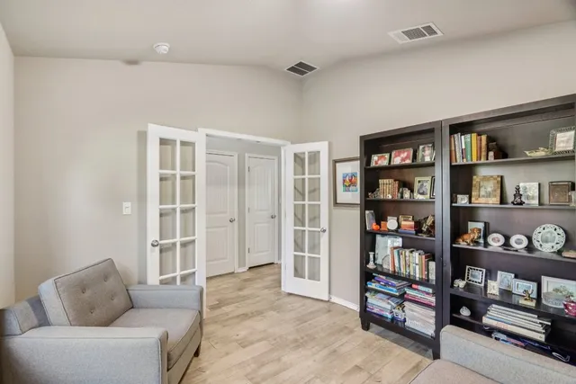 a living room with lots of furniture and a book shelf