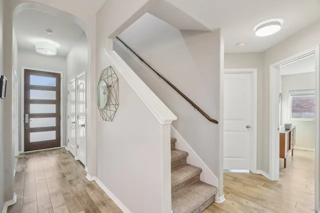 a view of entryway with wooden floor and stairs