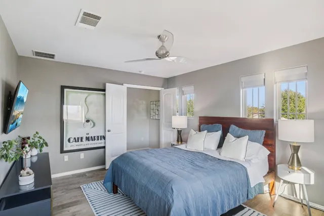 a bedroom with a bed and a potted plant