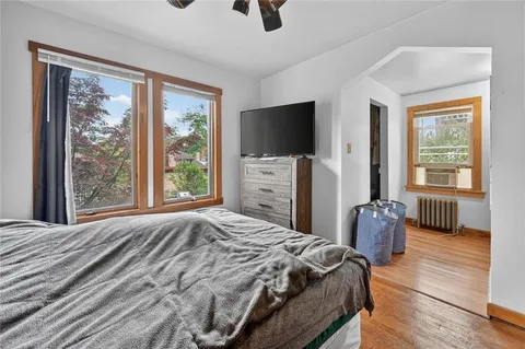 a bedroom with a bed a flat screen tv and a couch