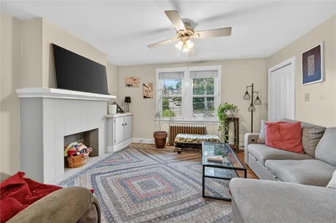a living room with furniture a flat screen tv and a fireplace