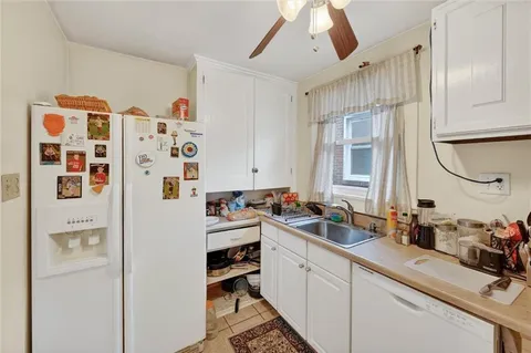a kitchen with a refrigerator and a sink