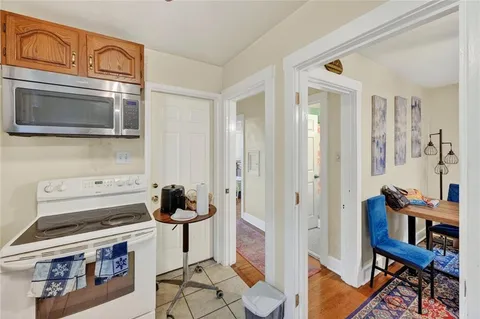a kitchen with stainless steel appliances granite countertop a stove and a microwave