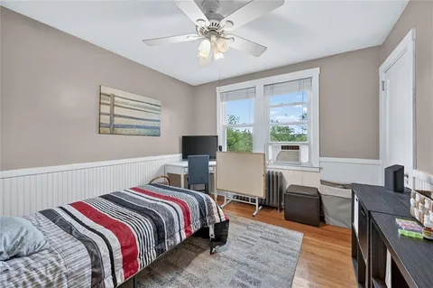 a bedroom with a bed and a desk