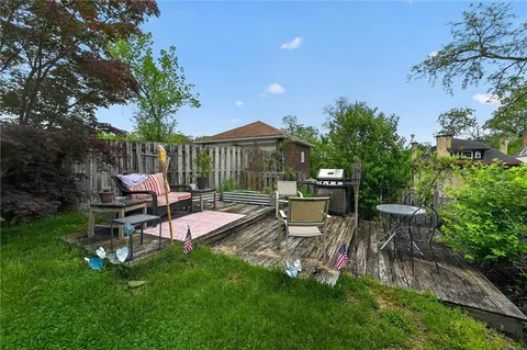 a swimming pool with outdoor seating and yard