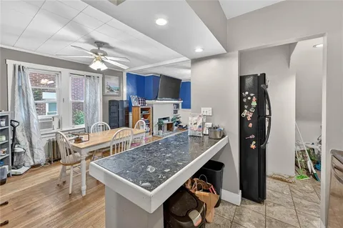 a kitchen with stainless steel appliances granite countertop a stove refrigerator and cabinets