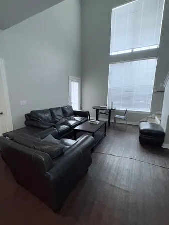 a living room with furniture and a large window