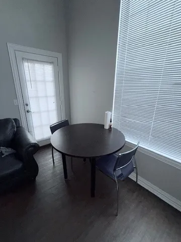 a view of a dining room with furniture and window
