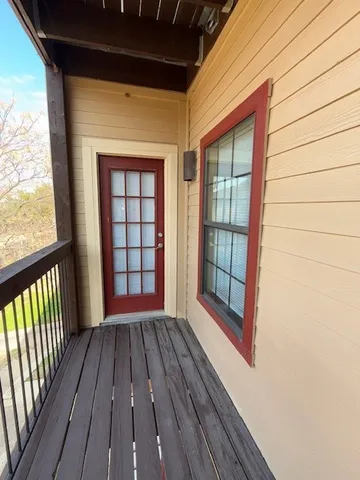 a view of hallway with wooden floor