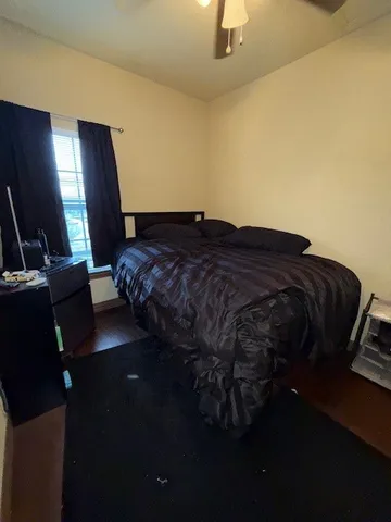 a bed sitting in a room next to a lamp