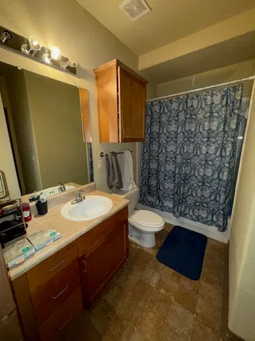 a bathroom with a sink vanity granite and a mirror