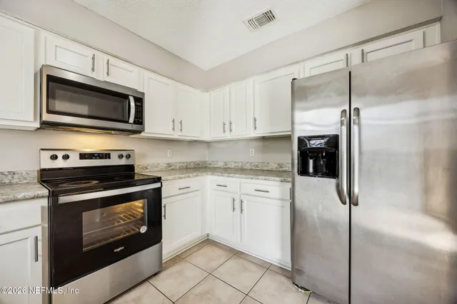 a kitchen with granite countertop a sink and a window