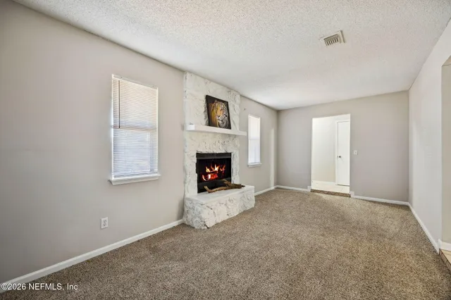 a view of an empty room and fire place