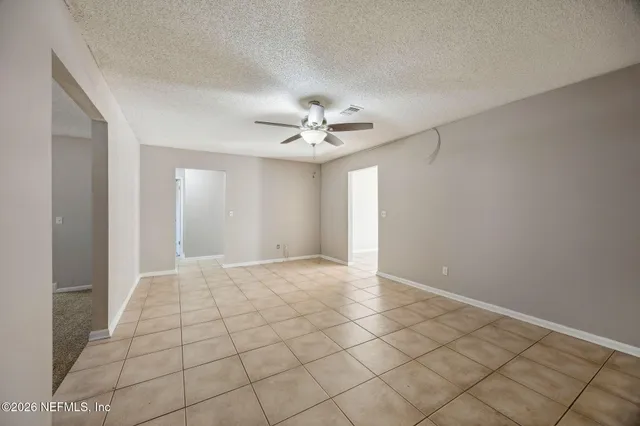 a kitchen with granite countertop white cabinets and appliances