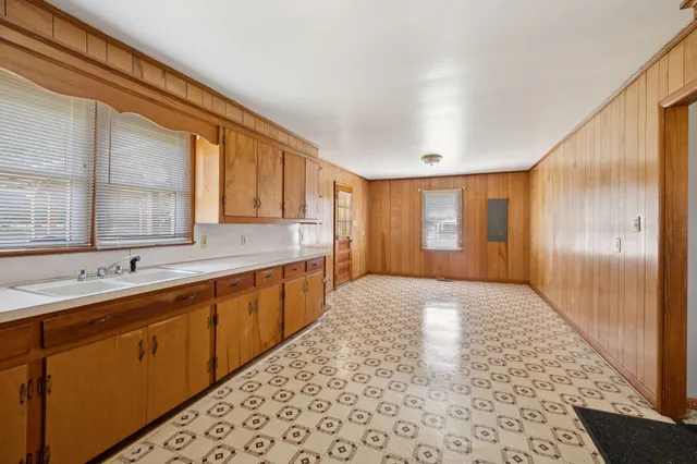 a view of a hallway with a wooden door