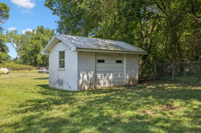 a front view of a house with yard and green space