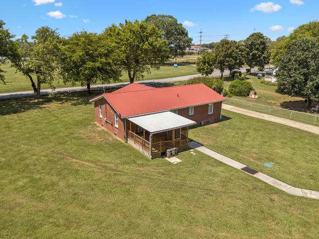 an aerial view of a multi story residential apartment building with yard