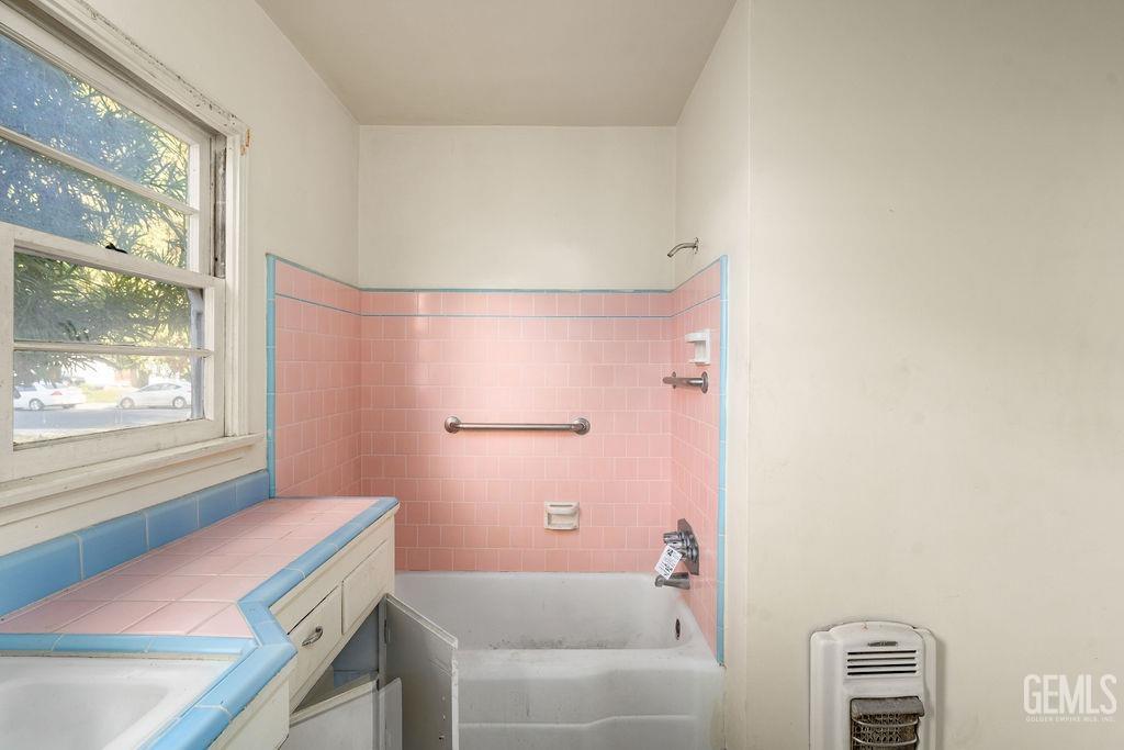 Undisclosed Address Bakersfield, CA 93305 - Photo 11 of 19 a bathroom with a bath tub and a shower