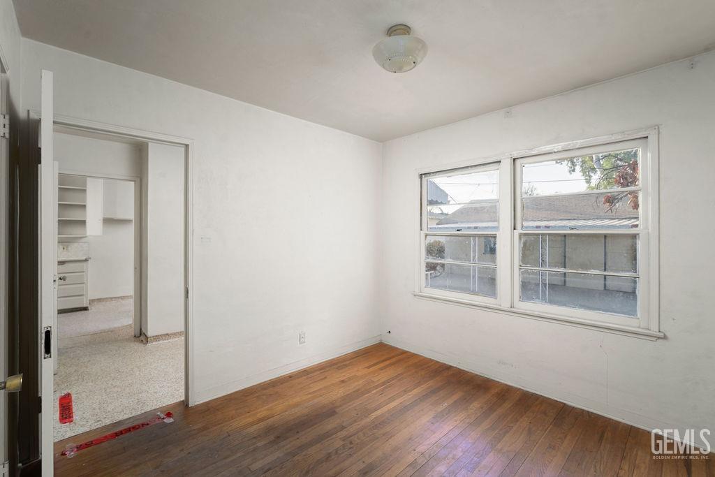 Undisclosed Address Bakersfield, CA 93305 - Photo 12 of 19 an empty room with wooden floor and windows