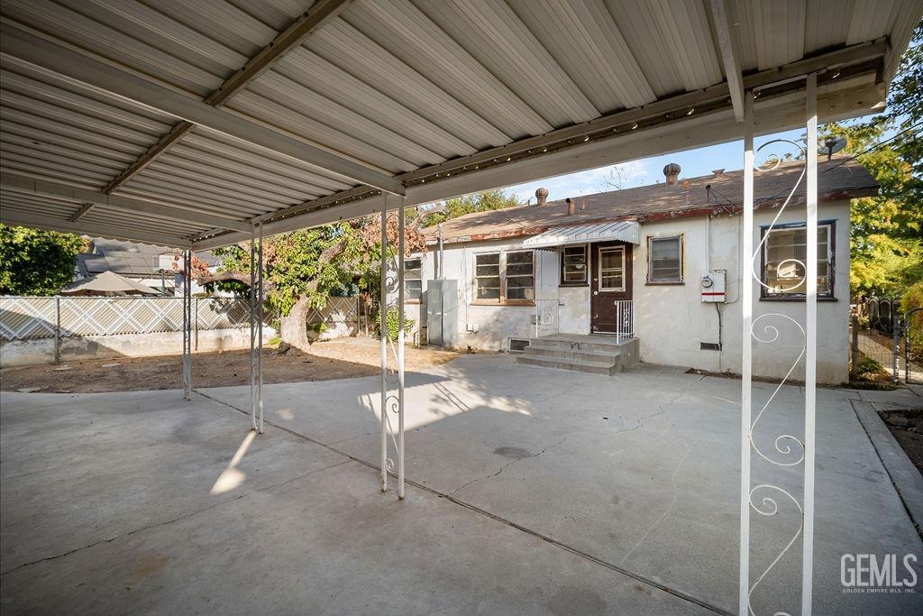 Undisclosed Address Bakersfield, CA 93305 - Photo 18 of 19 a patio with a table and chairs and potted plants