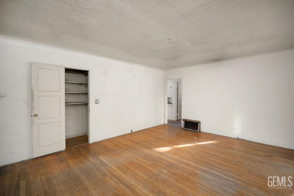 Undisclosed Address Bakersfield, CA 93305 - Photo 5 of 19 a view of empty room with wooden floor