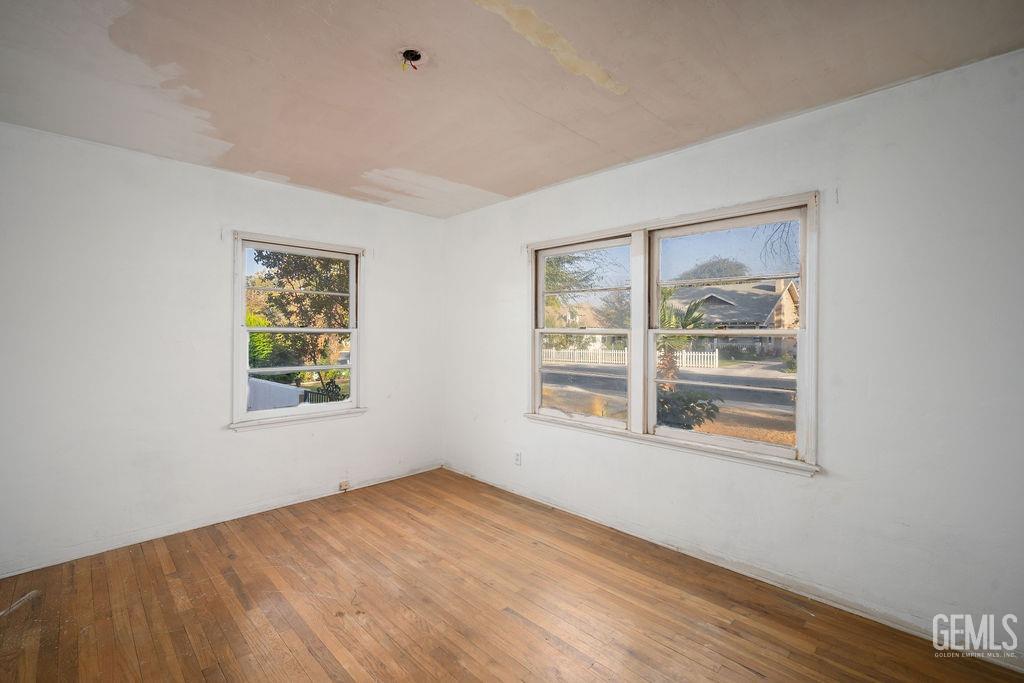 Undisclosed Address Bakersfield, CA 93305 - Photo 6 of 19 an empty room with wooden floor and windows