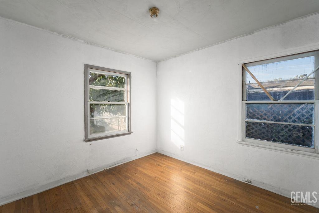 Undisclosed Address Bakersfield, CA 93305 - Photo 9 of 19 a view of an empty room with wooden floor and a window
