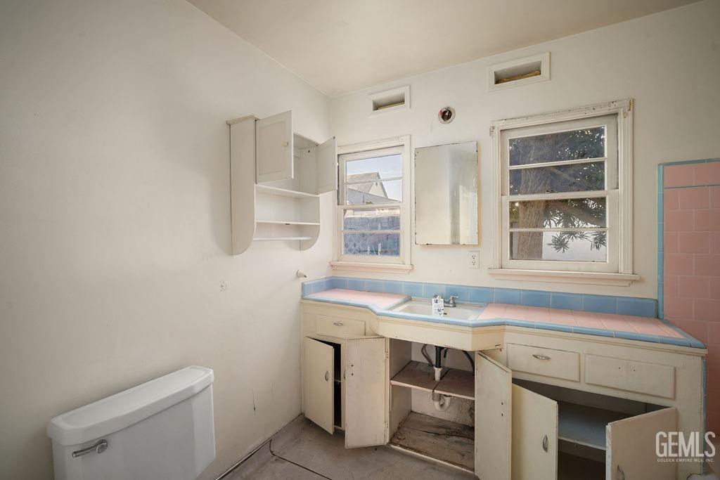 Undisclosed Address Bakersfield, CA 93305 - Photo 10 of 19 a bathroom with a sink a toilet and a window