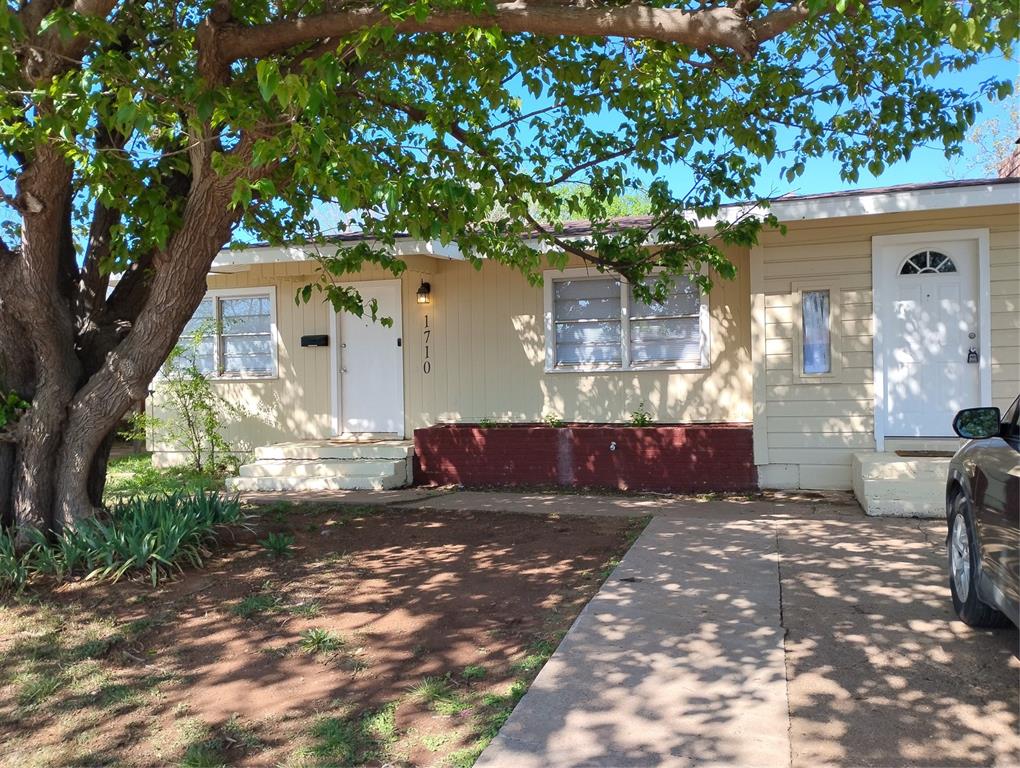 a view of house with yard