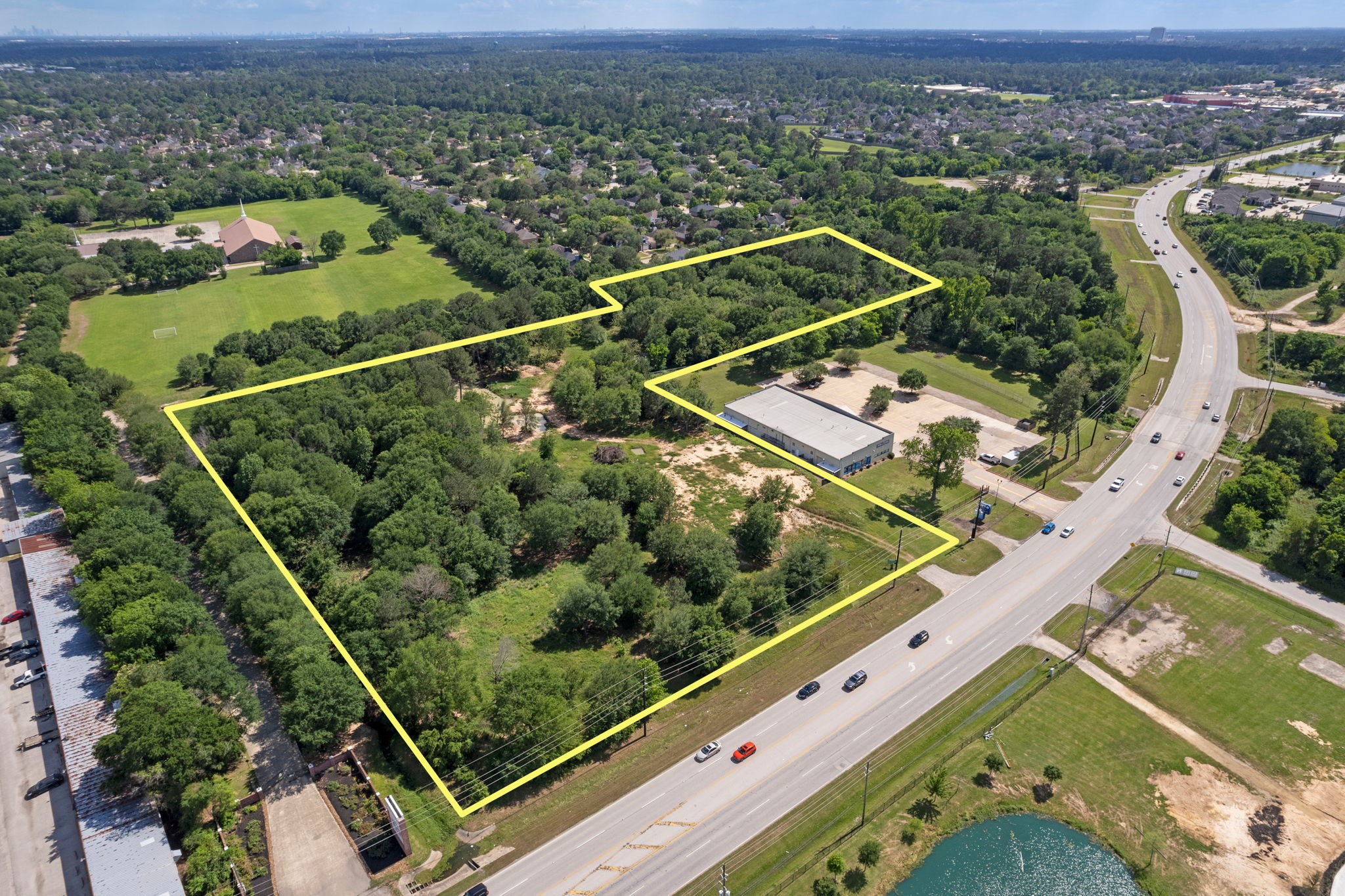 7803 Spring Cypress Road Spring, TX 77379 - Photo 1 of 14 an aerial view of a tennis ground and a ocean view