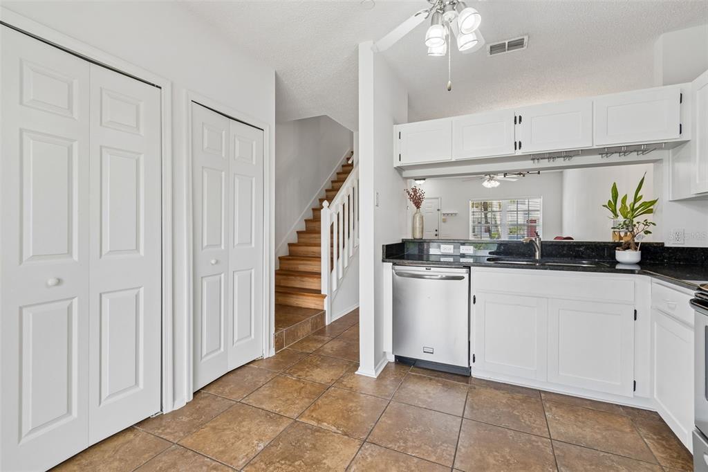 382 Countryside Key Boulevard Oldsmar, FL 34677 - Photo 16 of 58 a kitchen with white cabinets and white appliances
