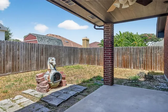 a view of a backyard with chair and a fire pit