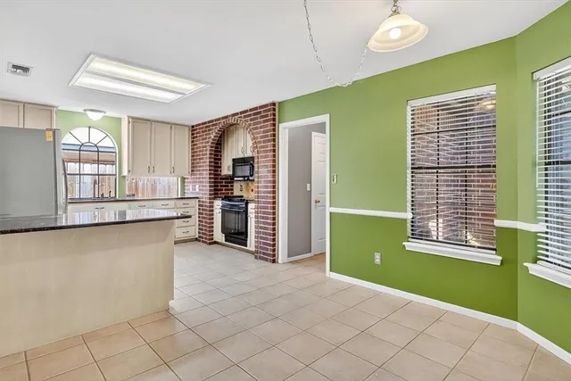 a kitchen with window and refrigerator