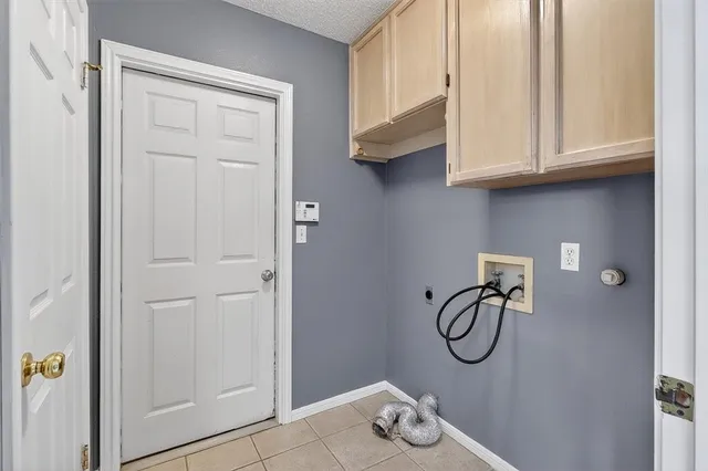 a view of a utility room with cabinets
