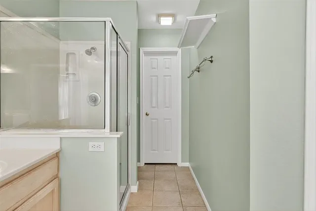 a bathroom with a shower and a sink