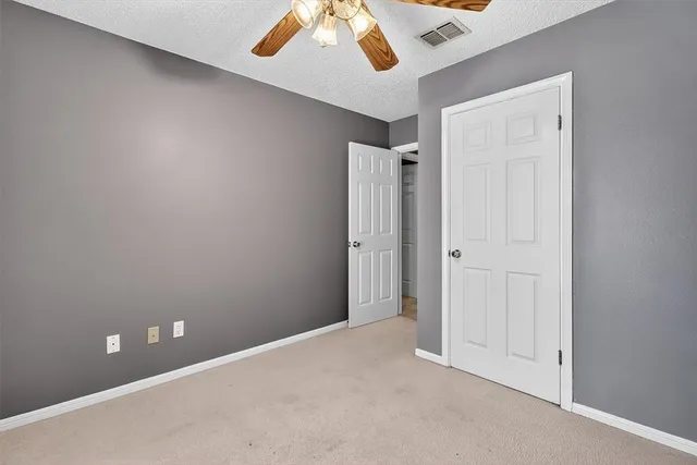 an empty room with a ceiling fan