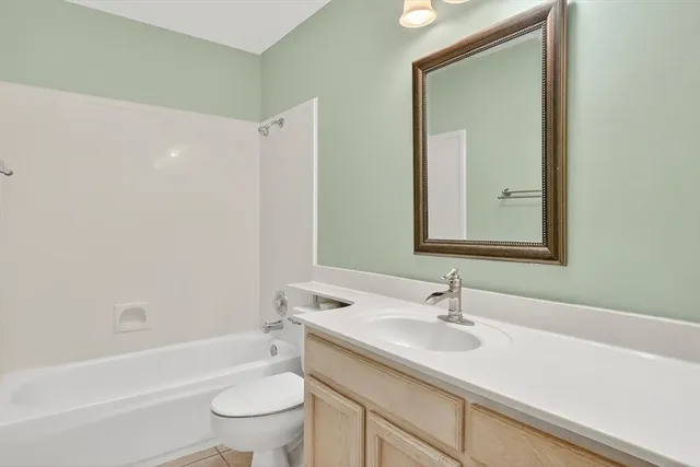 a bathroom with a sink a toilet and a large mirror