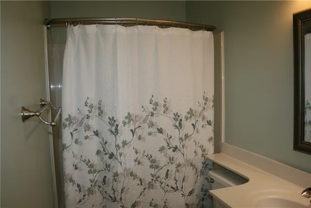 a bathroom with a shower curtain and a sink
