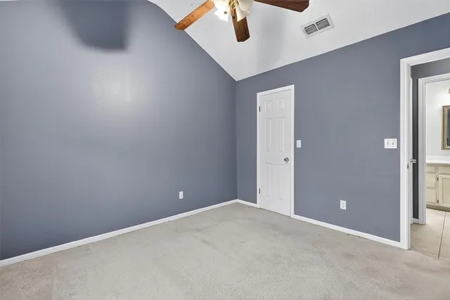 an empty room with a ceiling fan