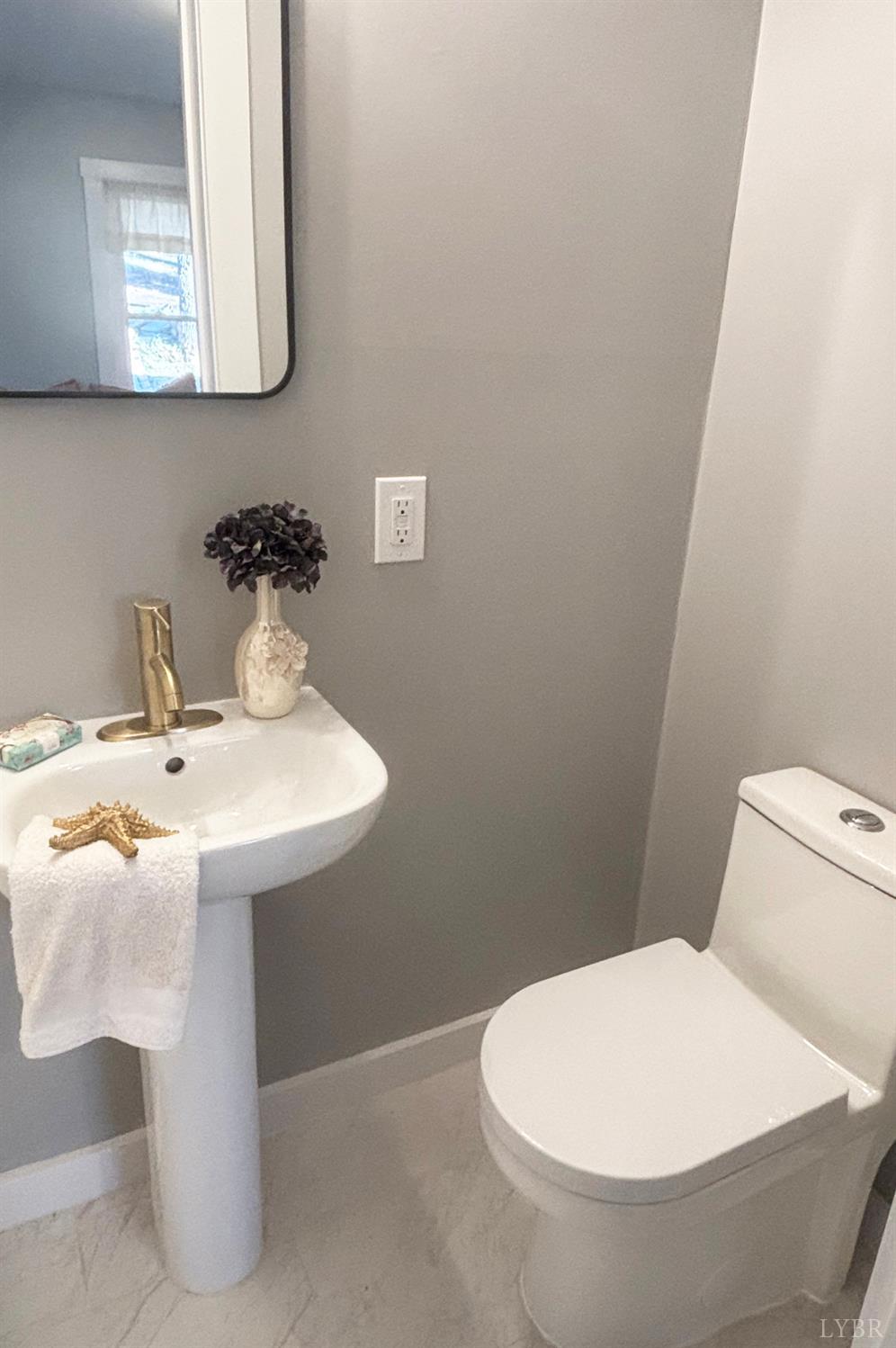 447 Matohe Road Monroe, VA 24574 - Photo 11 of 20 a bathroom with a sink mirror and toilet