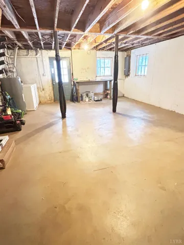 a view of water heater room with wooden floor