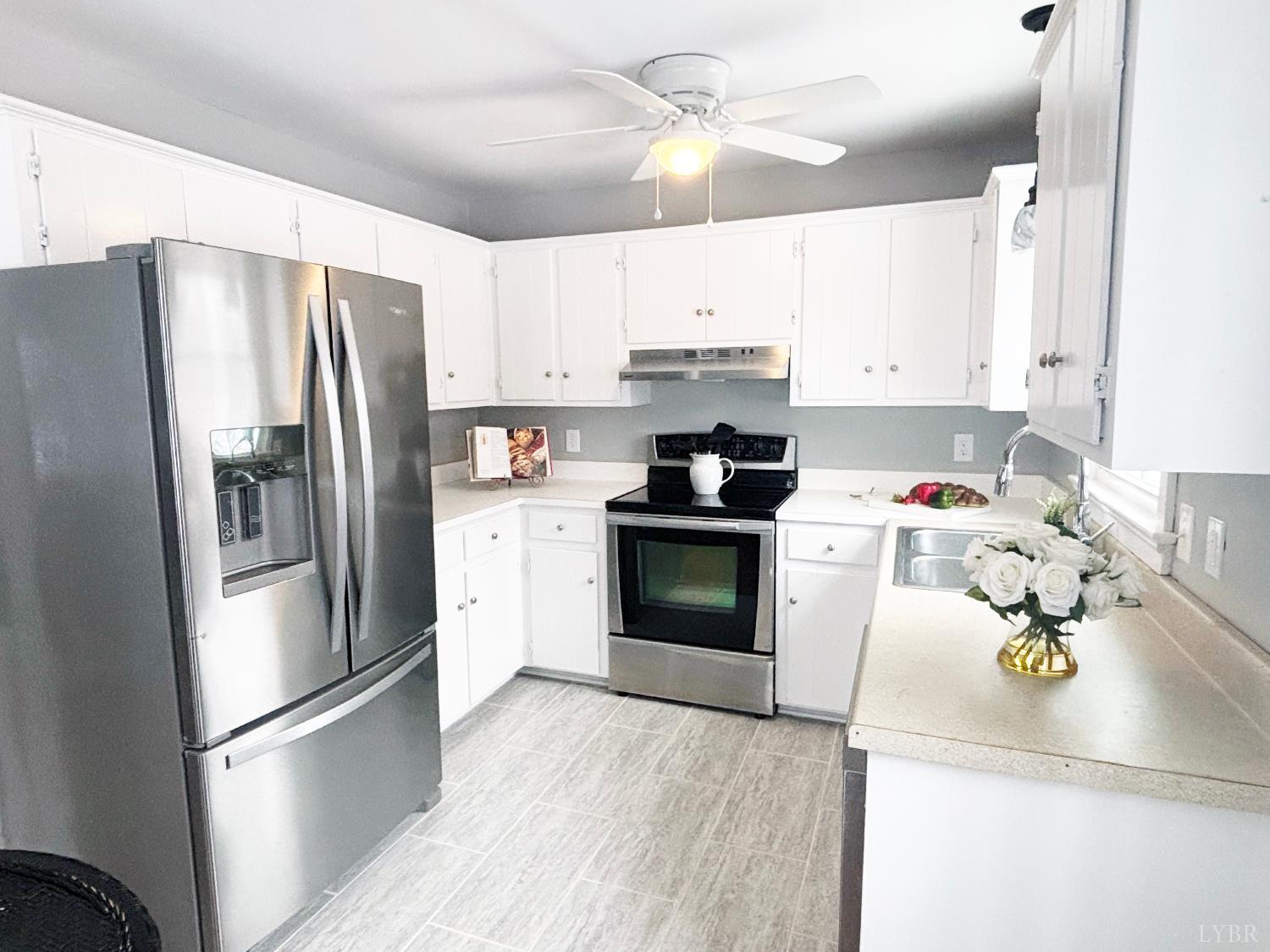 447 Matohe Road Monroe, VA 24574 - Photo 7 of 20 a kitchen with stainless steel appliances granite countertop a refrigerator a stove a sink dishwasher and a refrigerator with wooden floor