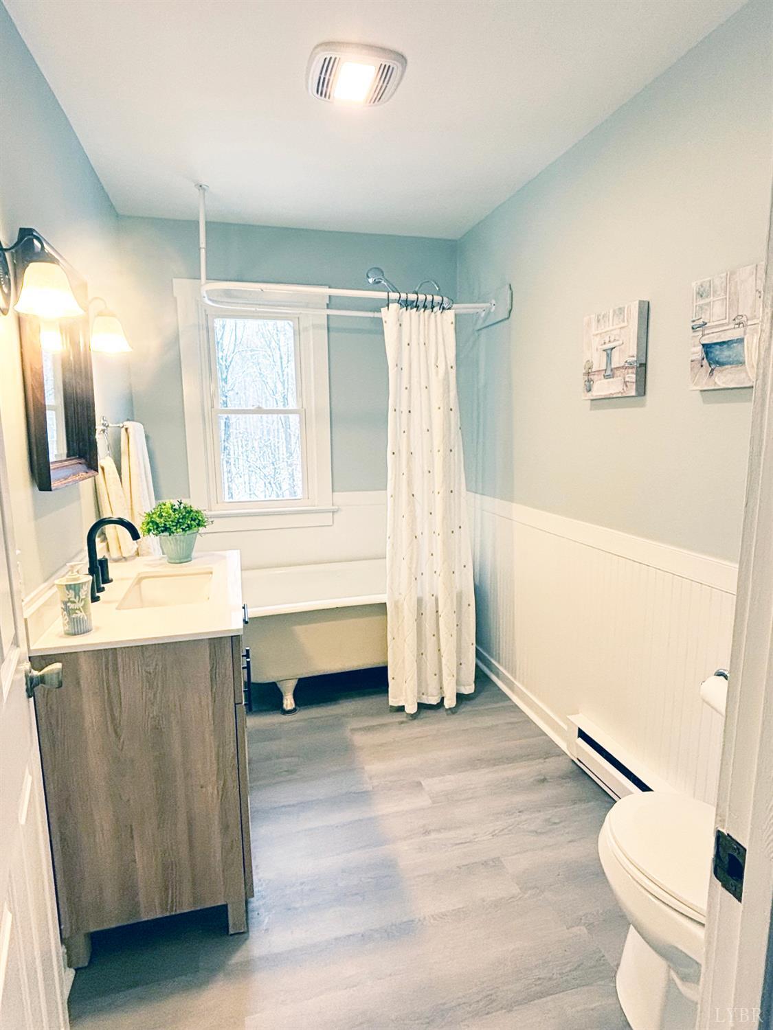 447 Matohe Road Monroe, VA 24574 - Photo 10 of 20 a bathroom with a tub sink toilet and a mirror