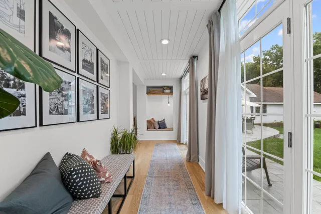 an aerial view of residential house with outdoor space and trees all around