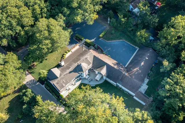 an aerial view of a house with a yard and garden