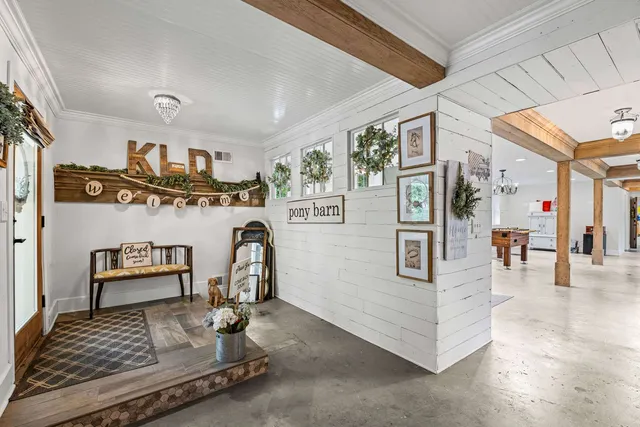 a view of a livingroom with furniture window and a kitchen