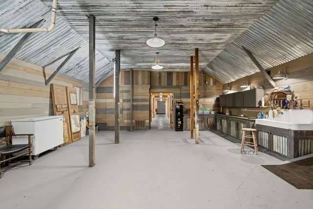 a living room with furniture a rug a fireplace and a large window