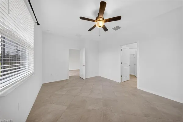 a view of a livingroom with a ceiling fan and window